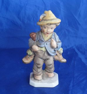FRIEDEL GERMANY FIGURINE BOY CARRYING BOOTS good condition
