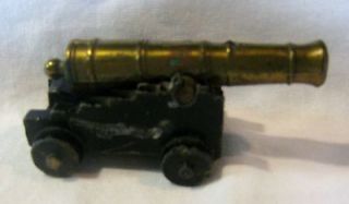 BLACK CAST IRON TOY CANNON WITH MOVING BRASS BARREL