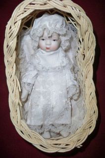 Porcelain Doll with Wicker Bassinet Arms Move
