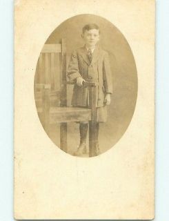   BOY WITH BUTTON SHOES BY THICK WOODEN CHAIR Nelson Nebraska NE v4971