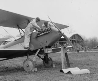 early 1900s photo Men examining airplane engine
