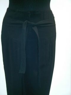 Alexander McQueen black trousers with a button flap at front and 