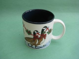 Darling Christmas themed mug with geese carring holly and ribbon 
