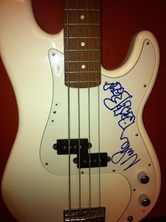   you are viewing a white samick bass guitar that has been single signed