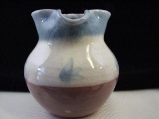 Here is a lovely little hand made in ENGLAND red clay pottery pitcher