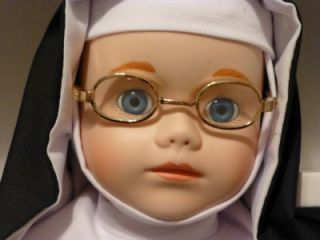 Sister Mary Francis has a beaded black rosary, is wearing glasses, has